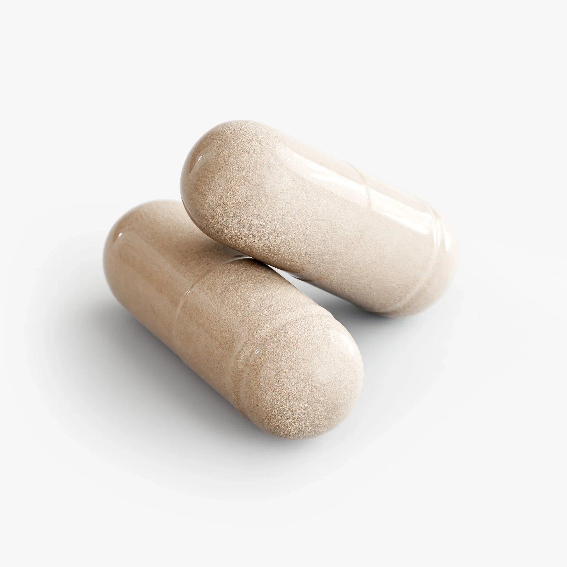 Two beige capsules on a white background